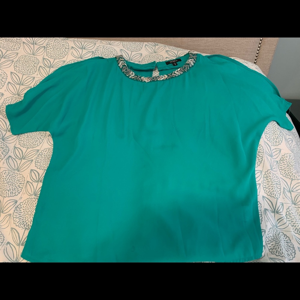 Teal top with open shoulders.